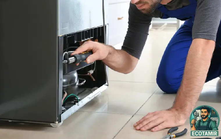 تعکیرکار مرد در حال تعمیر یخچال بکو 